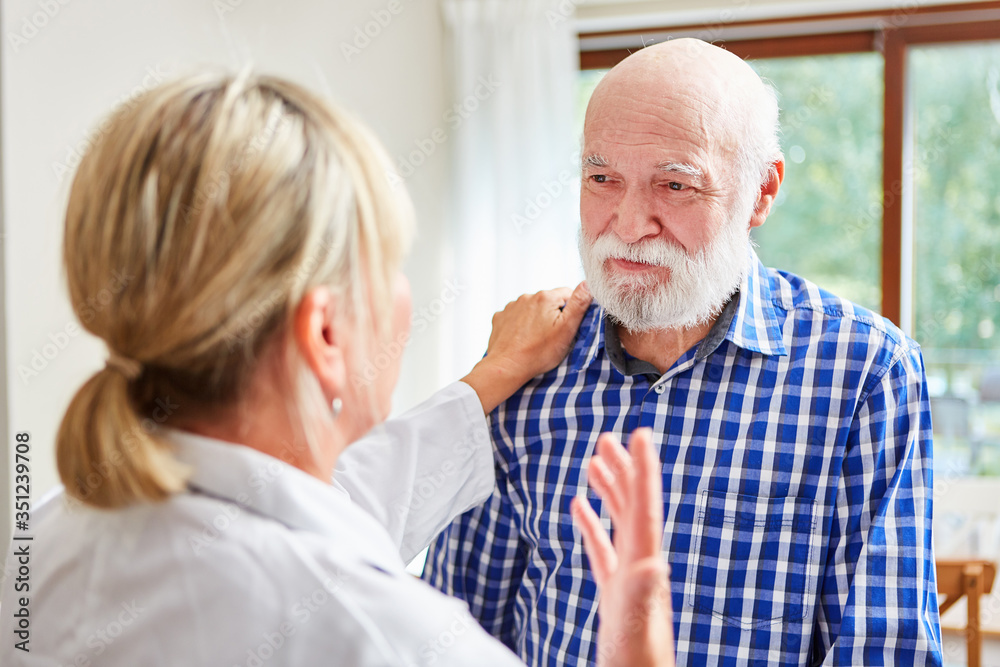 Family doctor consoles a senior man with dementia Family doctor consoles a senior man with dementia