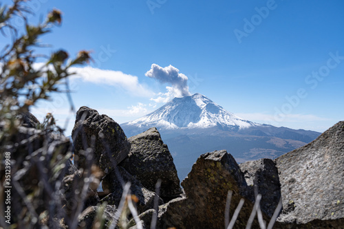 Active snowcapped Popocatepetl volcano with visible smoke, Mexico photo