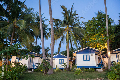 house on the beach near palm trees with a view of the sandy beach