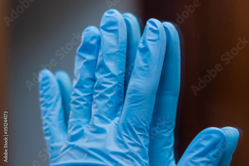 blue vinyl gloves on white background