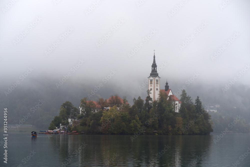 Misty Morning view of famous lake Bled and small island with a church in Slovenia