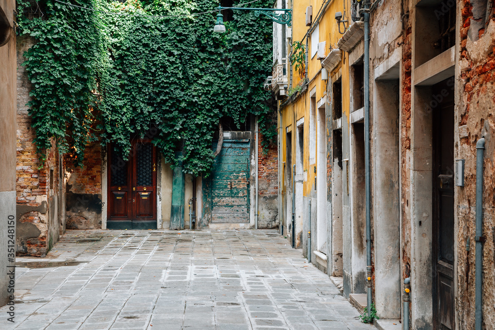 Fototapeta premium Old town street European old houses in Venice, Italy