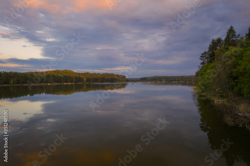 Evening sunset landscape with lake, spring and forest in Vereshchytsia, Lviv district. May 2020. Aerial drone view.