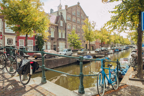 HAARLEM, NETHERLANDS, AUGUST 2019: Canal with historic houses in old Haarlem, the Netherlands, with lilac flowers. Europe tourism