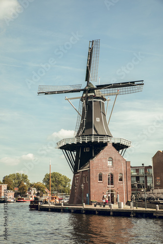 HAARLEM, NETHERLANDS, AUGUST 2019: Medieval Adriaan windmill in Haarlem, the Netherlands in summer © Aitor
