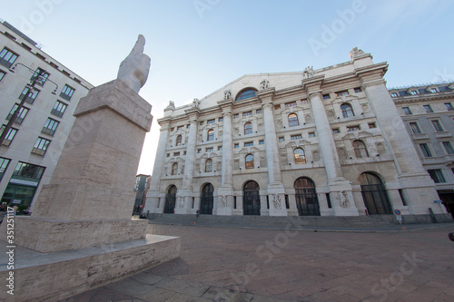 Fototapeta Naklejka Na Ścianę i Meble -  Milan, Italy - June 13, 2017: street view of Piazza Affari, the financial and economics center of Milan. Shot is taken at sunset, the streets are empty.