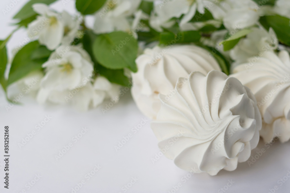 Delicate apple marshmallows decorated with a beautiful flowering branch Delicate apple marshmallows decorated with a beautiful flowering branch