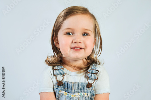 Portrait of 2 year old happy smiling baby on white background. 