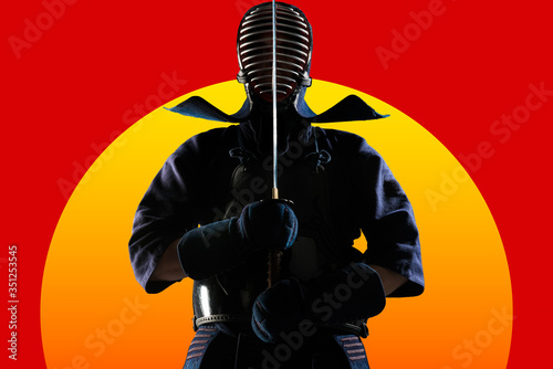 Collage of Kendo fighter with bamboo sword on sunrise background. Isolated with clipping path. (poster design)