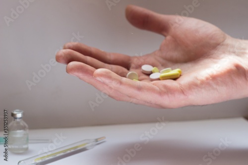 tablets in a man s hand on a white background