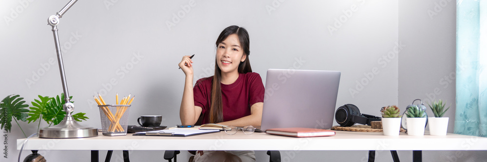beautiful young asian woman working remotely from home and smiling while lying, has good relationships with with a funny assistant dog pet, home work pets concept. beautiful young asian woman working remotely from home and smiling while lying, has good relationships with with a funny assistant dog pet, home work pets concept.