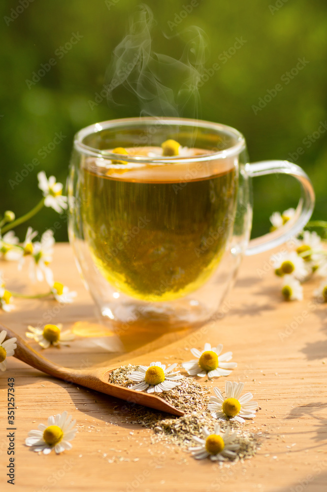 Chamomile flowers and chamomile tea. Herbal chamomile tea. Close-up. Chamomile flowers and chamomile tea. Herbal chamomile tea. Close-up.