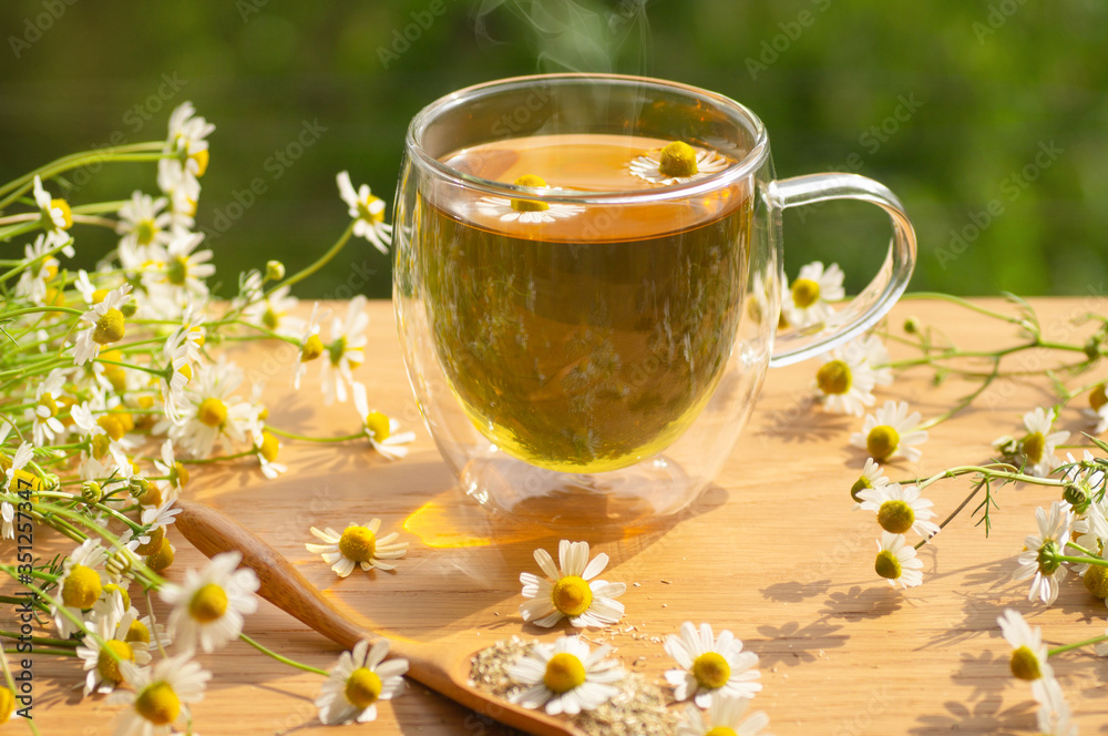 Chamomile flowers and chamomile tea. Herbal chamomile tea. Close-up. Chamomile flowers and chamomile tea. Herbal chamomile tea. Close-up.