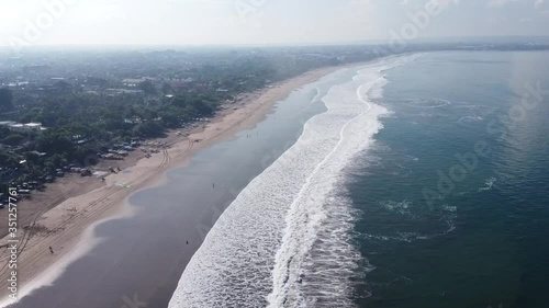 Wallpaper Mural Aerial view of sandy Bali beach, tourists swim in beautiful ocean in the evening. Indonesia Torontodigital.ca