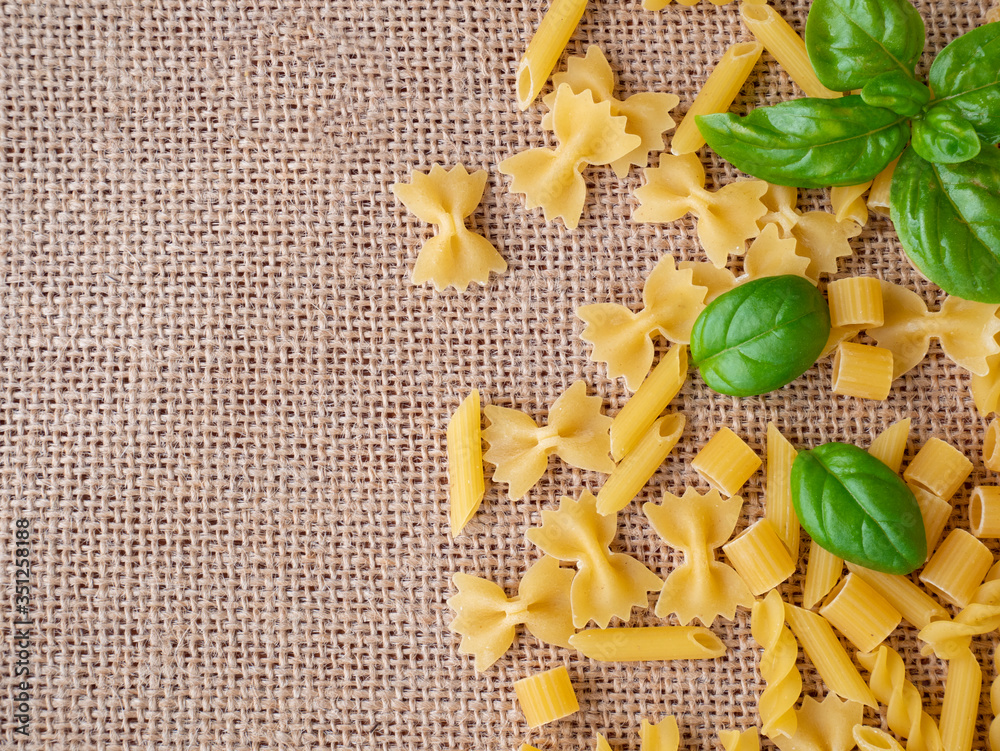 Varieties of raw pasta: farfalle, fusilli, ditaloni rigati and penne
