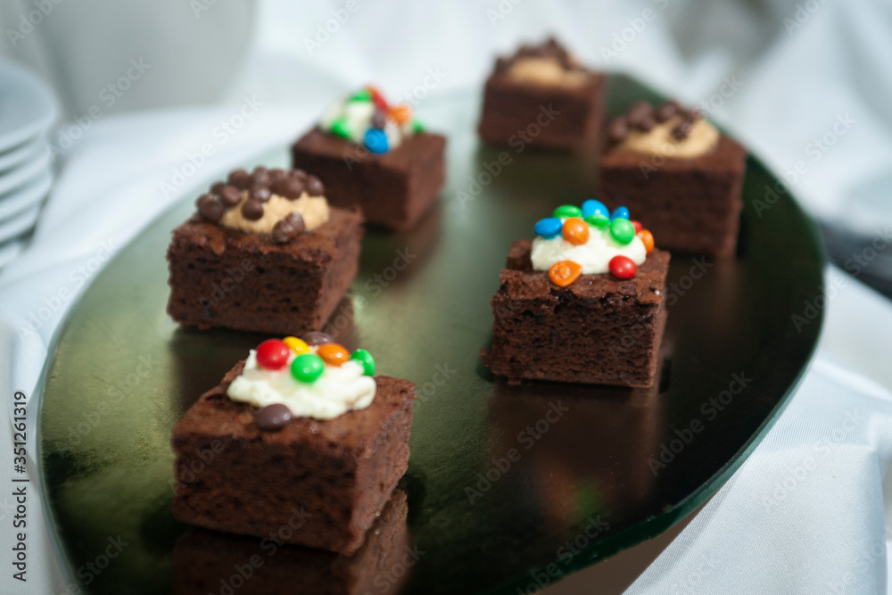brownie with cream and colored sprinkles on candy table at event 