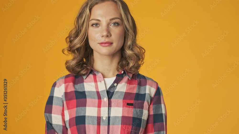 Young happy optimistic girl isolated over yellow wall background Young happy optimistic girl isolated over yellow wall background