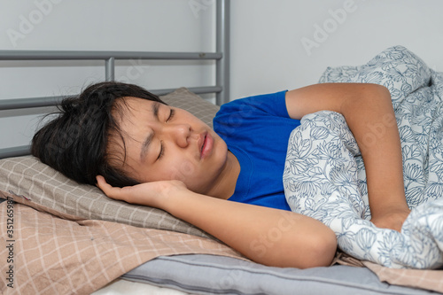 Young Asian boy having a bad sleep