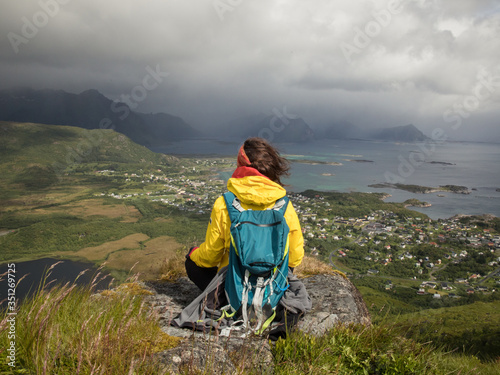 A hiker enjoys the mountain landscape in Lofoten. 