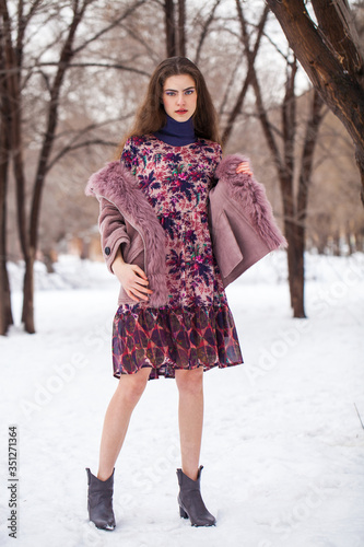 Portrait of a young beautiful woman in winter park © Andrey_Arkusha