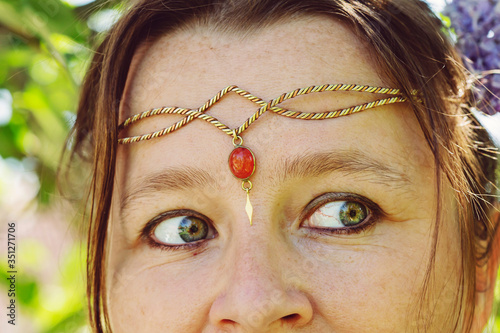 Closeup of young womans head wearing romantic metal tiara on her forehead