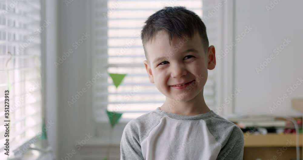 Toddler boy stares towards camera with inquisitive look - medium shot Toddler boy stares towards camera with inquisitive look - medium shot