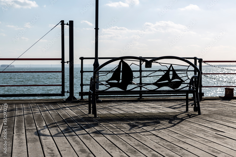 Obraz premium Metal Bench in Front of a Sea or Lake.