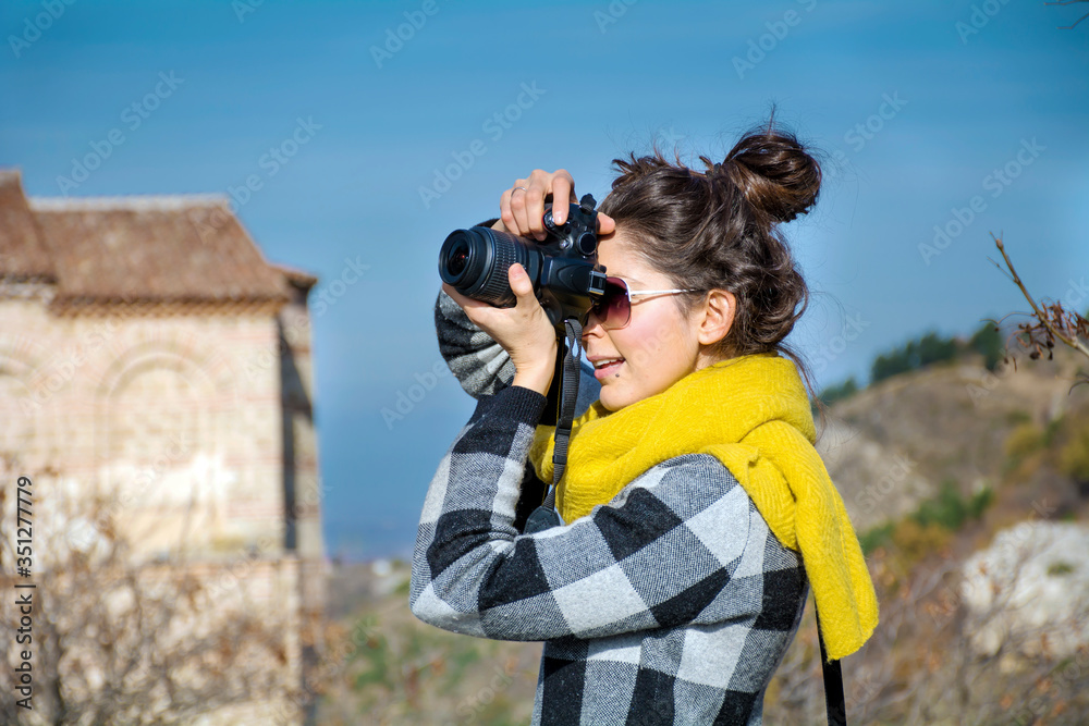 Woman Holding Photo Camera. .Travel Photographer Taking Photos Outdoor  in the City