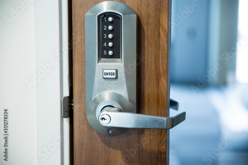 Digital smart door lock security system with a password, close up on numbers on the screen.
