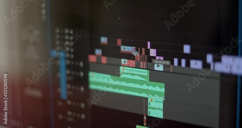Close up of video editing time line and computer monitor as video editor works on an edit photo