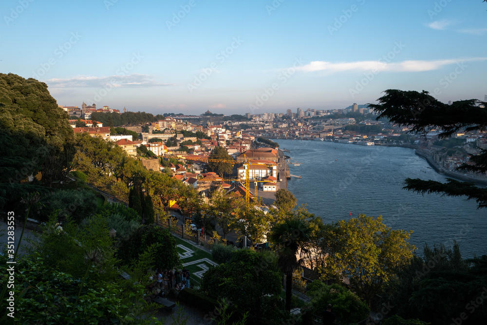 Public park of Porto at sunset with the Douro River in the background.