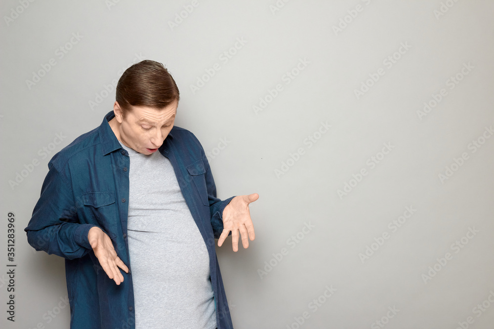 Portrait of man being surprised with his big stomach and fat body Portrait of man being surprised with his big stomach and fat body