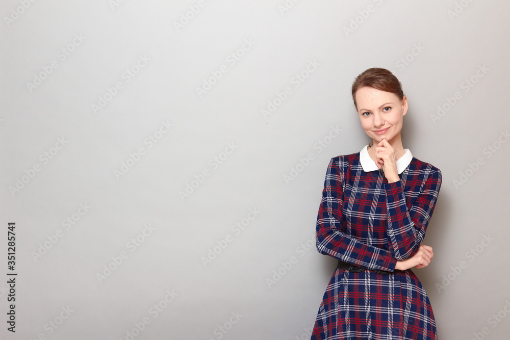 Portrait of happy girl touching chin with hand and smiling