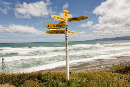sign on the beach with blue sky in New Zealand. 