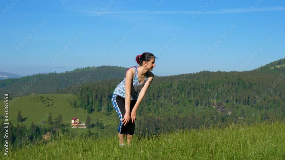 Knee warm-up against the backdrop of the mountain Knee warm-up against the backdrop of the mountain