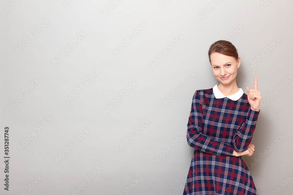 Portrait of happy girl pointing up with finger and smiling Portrait of happy girl pointing up with finger and smiling