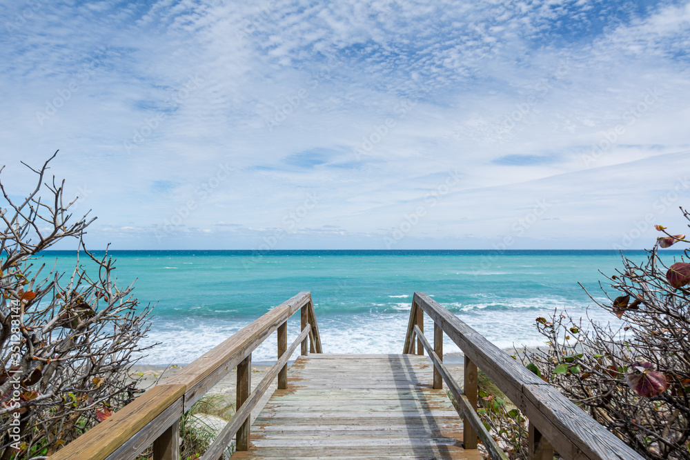 Wooden Walkway Leading Down to a Picturesque Turquoise Ocean