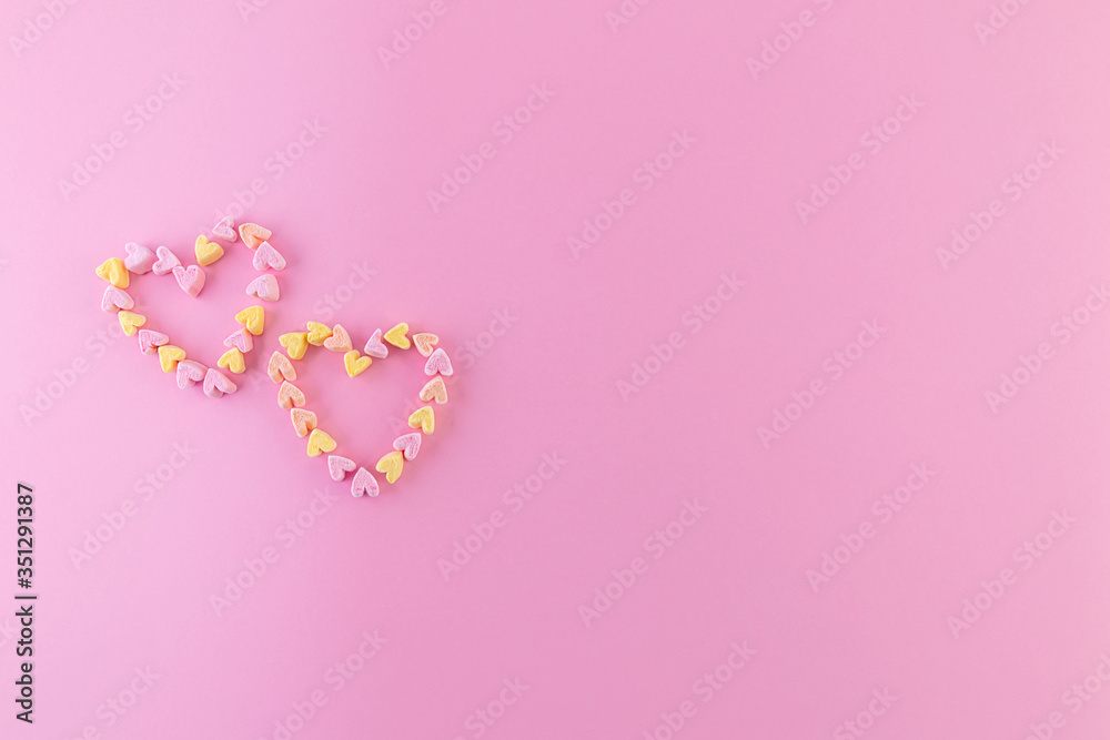 Minimalistic pink background with small hearts for a love card. Copy space.