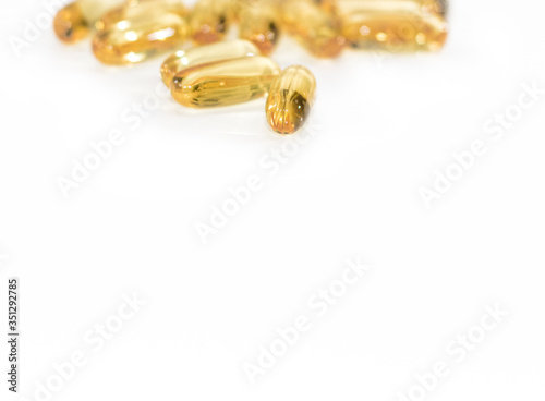 Omega 3 yellow soft gel pills isolated on white background. Copy space