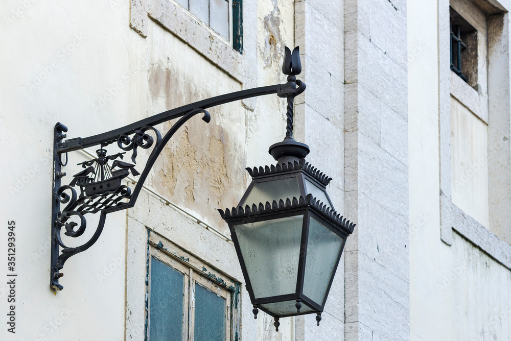 wrought iron lantern with the city's coat of arms: a caravel and two crows in Lisbon