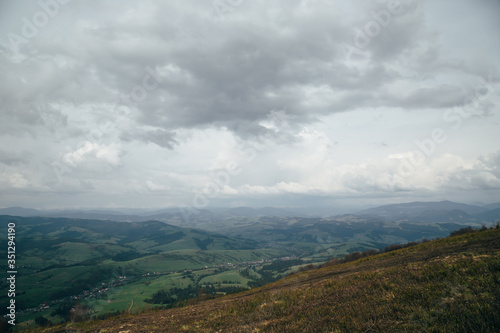 A view from the top of the mountain Gemba or Gimba down to the meadow and village Pilipec, Carpathian mountains, Ukraine. Silence and harmony of nature