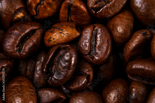 Coffee beans close-up. Macro shooting. Small depth of field. Blurred the edges of the frame.