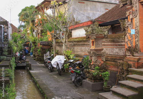 Scooters parked on back alley, in Ubud, Bali