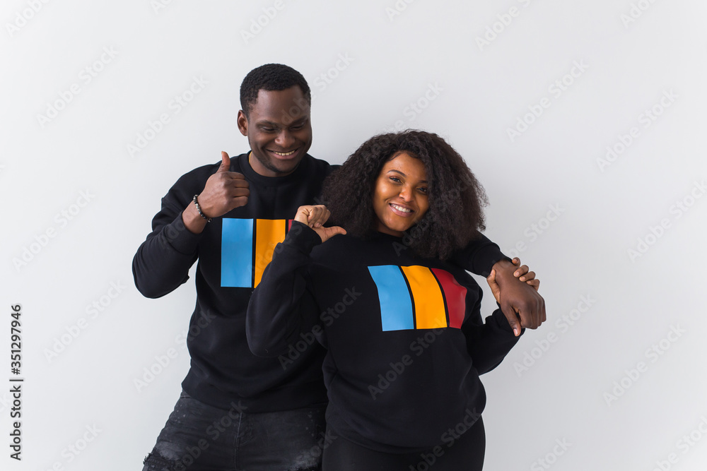 Happy African American woman and man have relationships, toothy smile, happy to meet with friends, dressed casually on white background. Emotions and friendship concept.