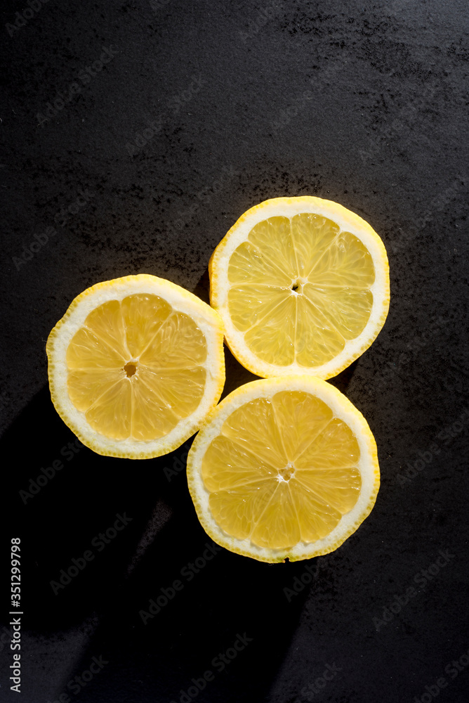 lemon slices on a black plate lemon slices on a black plate