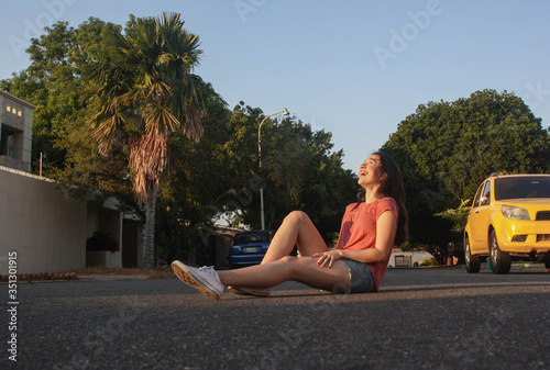 teenager posing at sunset in the neighborhood street © PaoloAntonio