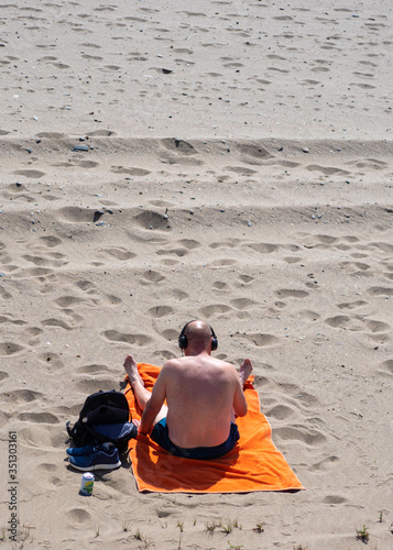 Primeros bañistas después del confinamiento disfrutando del sol y la playa photo