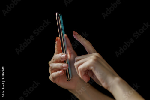 Woman hand holding smartphone. Payment or play.