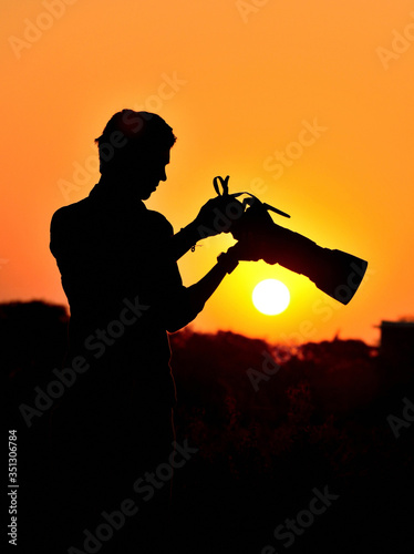 Silhouette of photographer when sunset