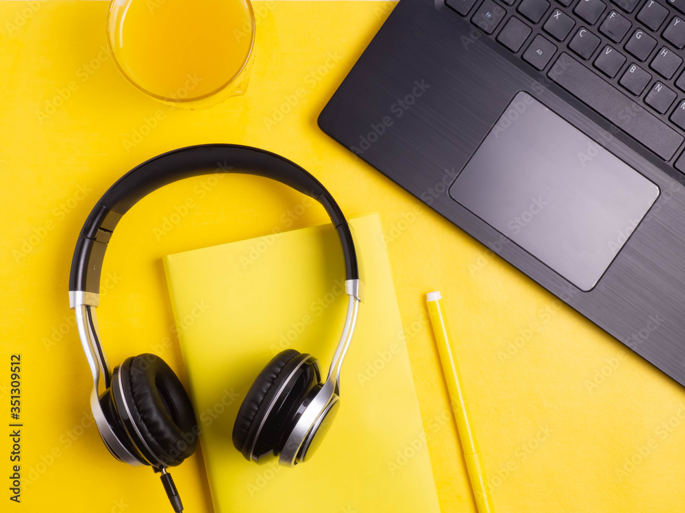 Online education or training concept, work online, top view. Work at home. Telecommuting. Laptop, books on a yellow background. Copy space Online education or training concept, work online, top view. Work at home. Telecommuting. Laptop, books on a yellow background. Copy space